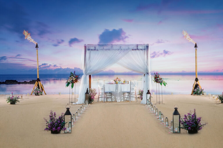Romantic private dinner setup on the beach at sunset at Sofitel Bali Nusa Dua