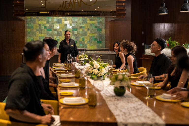 A group of people sitting on mama's table